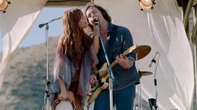 Riley Keough and Sam Claflin perform onstage in Daisy Jones And The Six