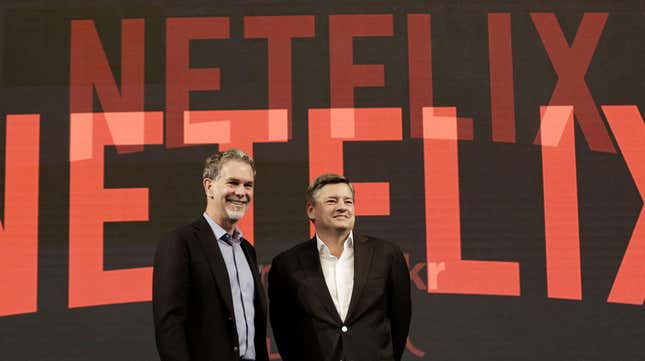 Photo of Reed Hastings and Ted Sarandos in front of Netflix logo