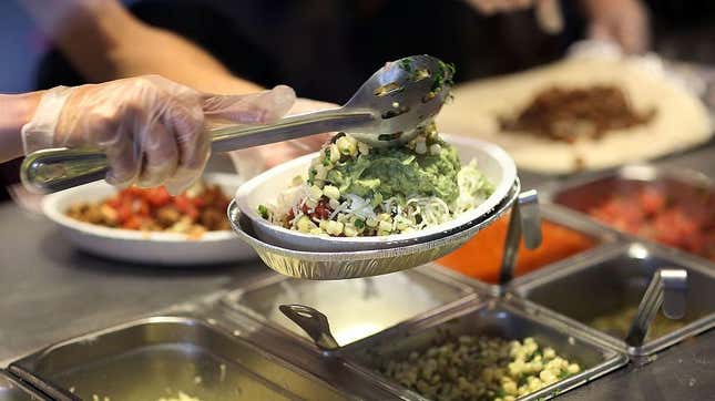 Chipotle order counter with ingredients being ladled into burrito bowl