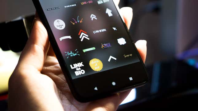 A picture of an Android phone showing the sticket feature in Instagram, and the stickers say "Link in Bio" 