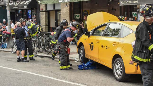 Firefighters work at the scene after a taxi crashed into Westville restaurant injuring eight people on July 11, 2019 in the Hell's Kitchen neighborhood of New York City.