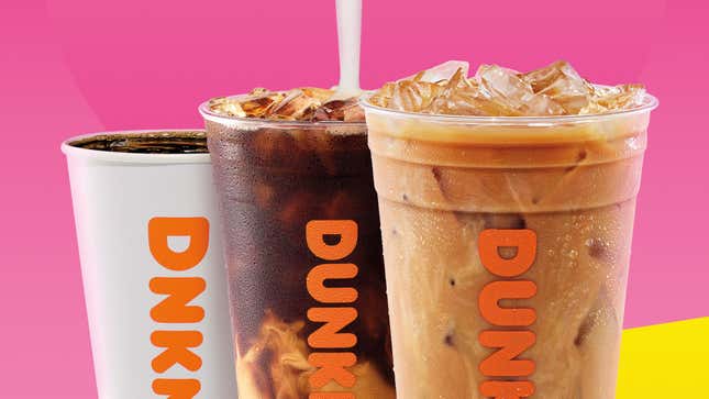 Coconut milk pouring into Dunkin' coffee on pink and yellow background