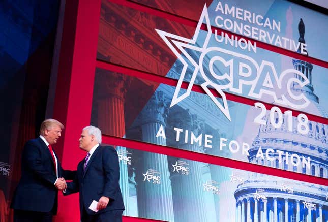Donald Trump shakes hands with Matt Schlapp, chairman of the American Conservative Union, during the 2018 Conservative Political Action Conference (CPAC) at National Harbor in Oxon Hill, Maryland, February 23, 2018.