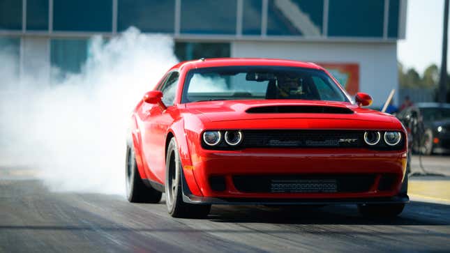 A Dodge Challenger SRT Demon smoking its tires, as a Demon should, and as a Demon cannot do in a showroom.