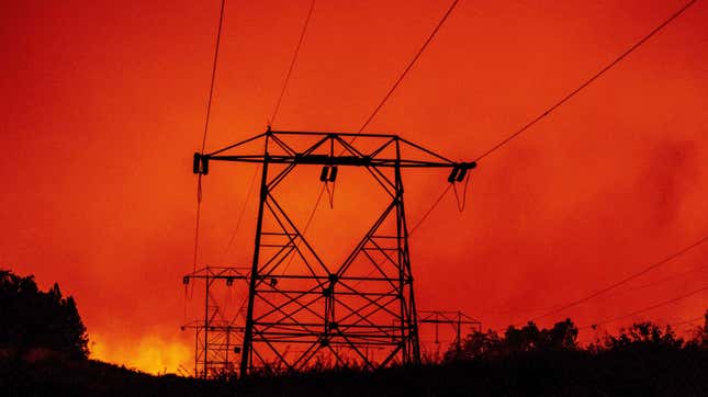 High-tension power lines are seen against a burning landscape during the Creek Fire in Fresno County, California.