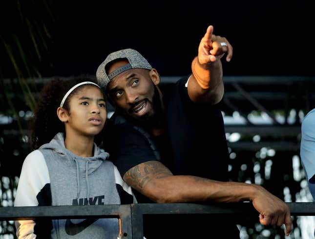 In this file photo legendary Los Angeles Laker Kobe Bryant and his daughter Gianna watch the  U.S. national championships swimming meet Thursday, July 26, 2018, in  Irvine, Calif. 