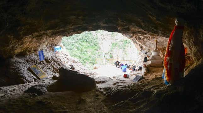 The entranceway of Baishiya Karst Cave, featuring various Buddhist ornamentations and sacraments.