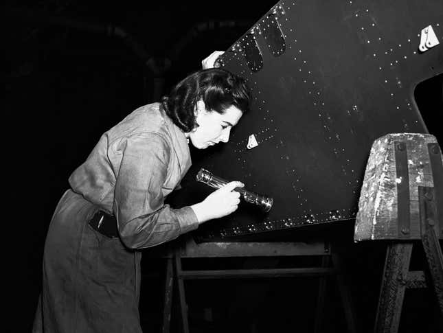 Mrs. Williams on the many works inspectors casting her critical eyes over the work done by her fellow men and women workers on parts for the Halifax bombers, somewhere in England, on April 15, 1942.