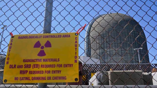 A sign warning of radioactive materials is seen on a fence around a containment building at Indian Point Nuclear Power Plant.