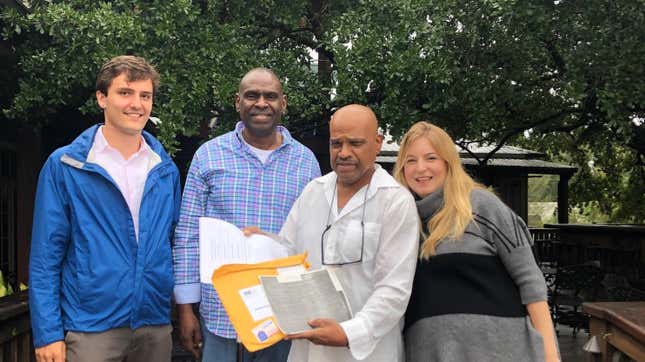 Elvis Brooks (holding papers, center), flanked by his brother Aaron Brooks, Innocence Project New Orleans attorney Charell Arnold (right) and investigator Jack Largess (left) after Elvis Brooks’ release from prison Oct. 16, 2019, after spending 42 years behind bars for a murder he says he didn’t commit