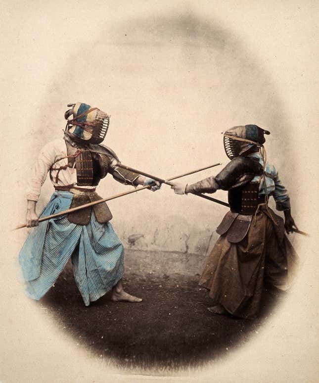 Japan: spear-men wearing protective clothing and masks. Coloured photograph by Felice Beato, ca. 1868
