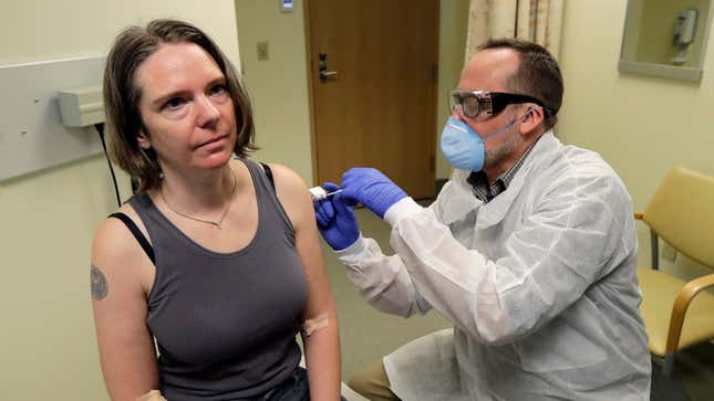 A pharmacist gives Jennifer Haller, left, the first shot in the first-stage safety study clinical trial of a potential vaccine for covid-19 on March 16, 2020, at the Kaiser Permanente Washington Health Research Institute in Seattle.