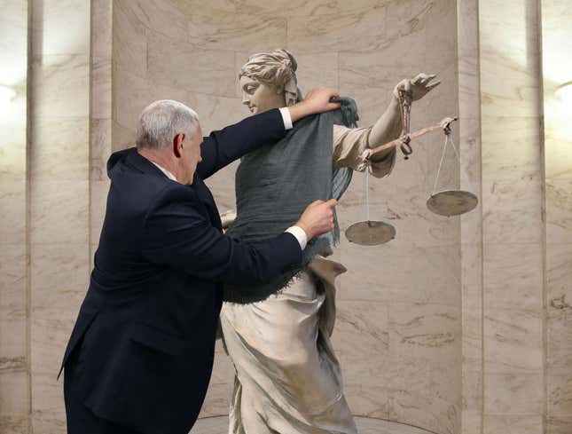 Image for article titled Mike Pence Drapes Shawl Over Immodest Lady Justice Statue