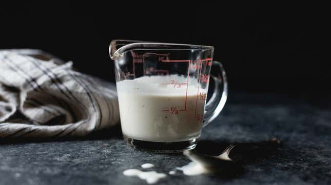 Glass measuring cup full of buttermilk
