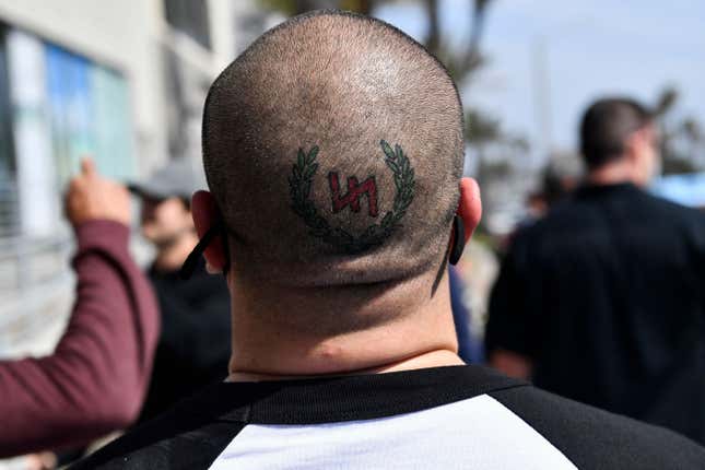 A tattoo detail on the head of a man as as he is confronted by anti-racism protesters following a planned “White Lives Matter’” demonstration on April 11, 2021 in Huntington Beach, California. 