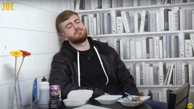 man slumped over against wall after eating too much