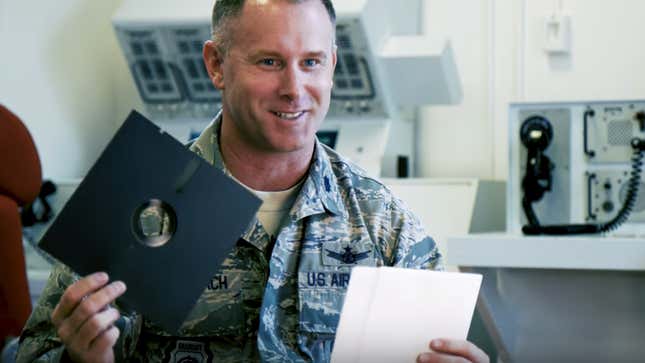 Lieutenant Colonel Jimmy Schlabach shows off a floppy disc used in the launch control center at the F.E. Warren Air Force Base for a Seeker video