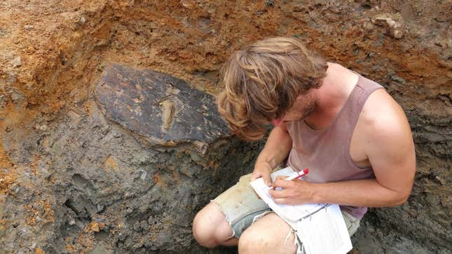 ULAS archaeologist Adam Clapton recording the shield when it was still in the ground.