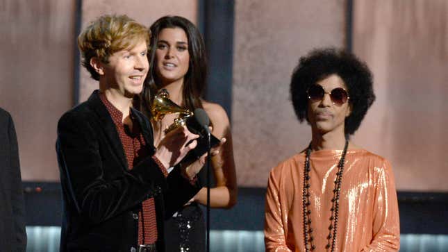 Beck (L) accepts the Album of the Year award for “Morning Phase” from musician Prince onstage during The 57th Annual GRAMMY Awards on Feb. 8, 2015, in Los Angeles.
