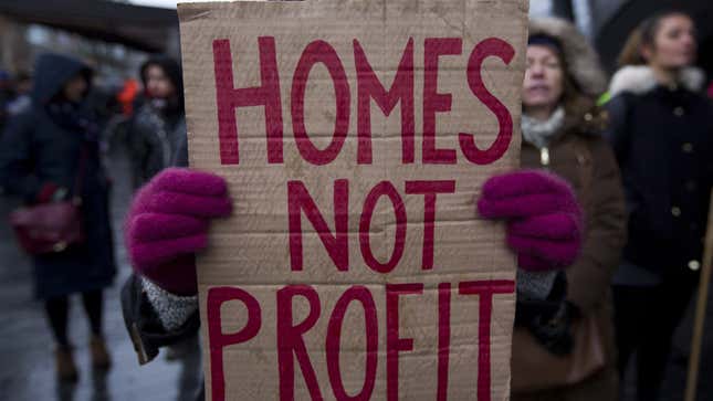 A woman in the UK protesting evictions and lack of affordable housing in 2015.
