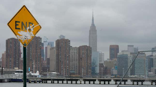 The Empire State Building rises over empty piers on the East River on March 25, 2020 in New York.