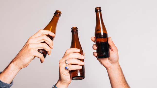 three hands holding up beer glasses