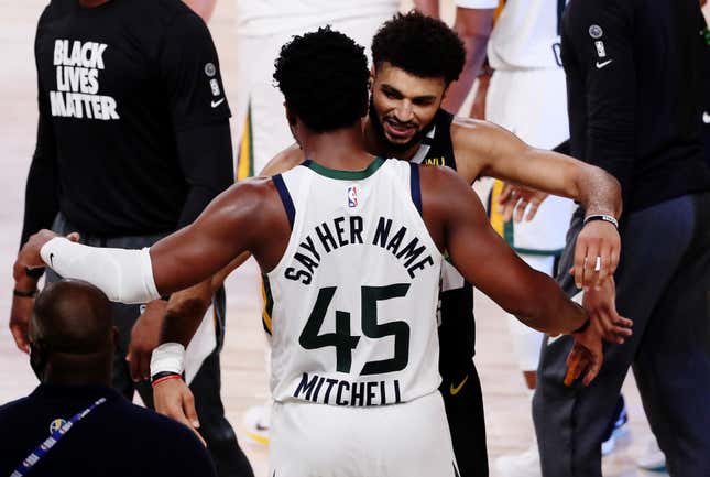 Donovan Mitchell #45 of the Utah Jazz hugs Jamal Murray #27 of the Denver Nuggets after the game ends and the Denver Nuggets wiin Game Seven of the Western Conference First Round during the 2020 NBA Playoffs at AdventHealth Arena at ESPN Wide World Of Sports Complex on September 01, 2020 in Lake Buena Vista, Florida.