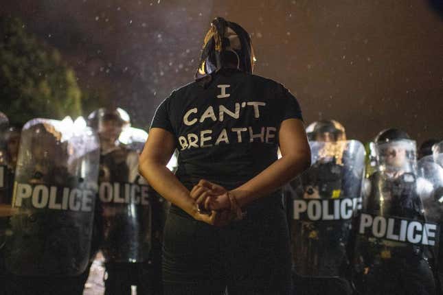 Protesters face off with police outside the White House in Washington, DC, early on May 30, 2020 during a demonstration over the death of George Floyd, a black man who died after a white policeman knelt on his neck for several minutes.