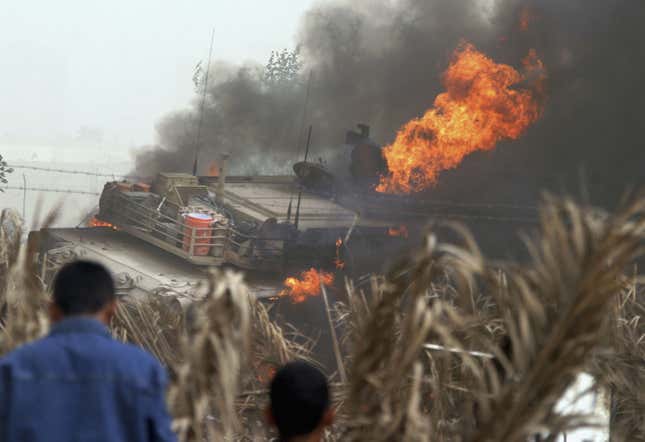 An American M1 Abrams tank burning east of Baghdad, 2006, after striking an improvised explosive device.