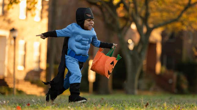 Little boy trick-or-treating in Batman costume
