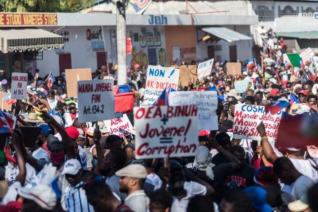 Haitians protesters march through the streets on February 28, 2021 in Port-au-Prince, to denounce the upsurge in kidnappings committed by gangs and the inclinations for a new dictatorship they say the government wants to set up. 