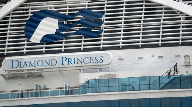 Passengers are seen on the deck of the quarantined Diamond Princess cruise ship, docked at the Daikoku Pier on February 20, 2020 in Yokohama, Japan.