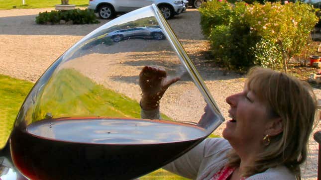 woman drinking from enormous wine glass