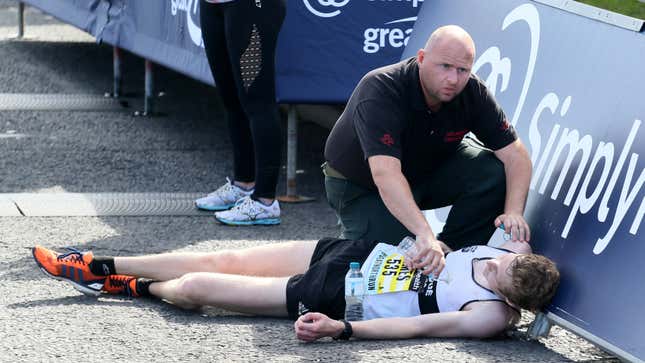 Image for article titled Marathon Runner Collapses A Little Too Early To Be Compassionately Helped Across Finish Line