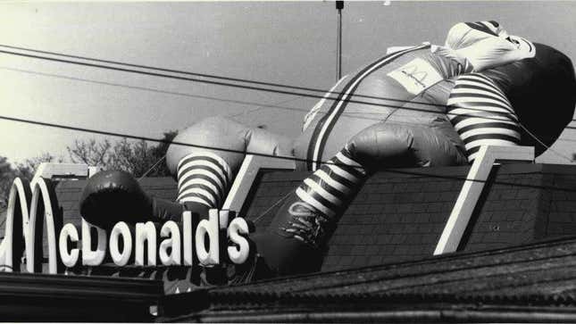 A Ronald McDonald inflatable wilts atop a restaurant franchise location