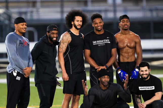 Colin Kaepernick, center, stands with Bruce Ellington, Brice Butler, Jordan Veasy, and Ari Werts during the Colin Kaepernick NFL workout held at Charles R. Drew High School on Nov. 16, 2019, in Riverdale, Ga.