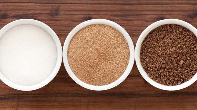 Three dishes on countertop: white sugar, light brown sugar, and dark brown sugar