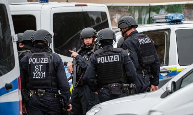 Police block access to a street near the scene of a shooting that left two dead in Halle, Germany