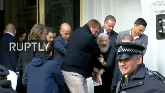 Julian Assange being dragged out of the Ecuadorian embassy in London, England by British Police on Thursday morning