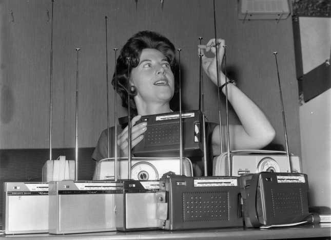 1962: A woman inspects the aerials of Floret transistor radios at the Radio Show at Earl’s Court, London.