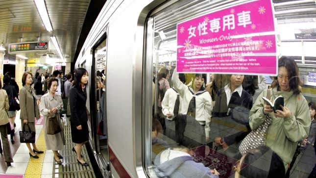 Female passengers board a “Women Only” carriage at a metro station on May 11, 2005 in Tokyo, Japan. 