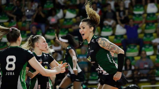 Volleyball player Tiffany Abreu, right, celebrates with teammates during a Brazilian volleyball league match in Bauru, Brazil. Abreu became the first transgender player in the top women’s volleyball league in 2017.