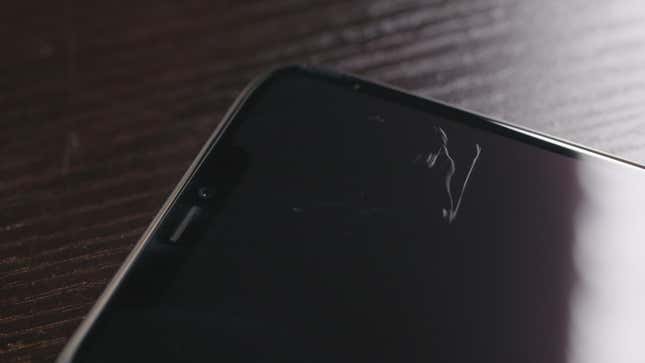 The front glass of an iPhone 11 Pro Max after a casual run-in with a rivet on my blue jeans.