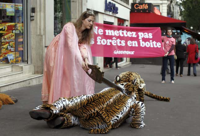 Image for article titled Here Are Some Pictures of Greenpeace Barbie Cutting Off a Costume Tiger&#39;s Head With a Chainsaw