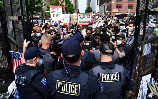 Black Lives Matter protesters are stopped by police at the entrance to a rally that US President Donald Trump will hold later in the evening at the BOK Center on June 20, 2020, in Tulsa, Oklahoma. - Hundreds of supporters lined up early for Donald Trump’s first political rally in months, saying the risk of contracting COVID-19 in a big, packed arena would not keep them from hearing the president’s campaign message. 