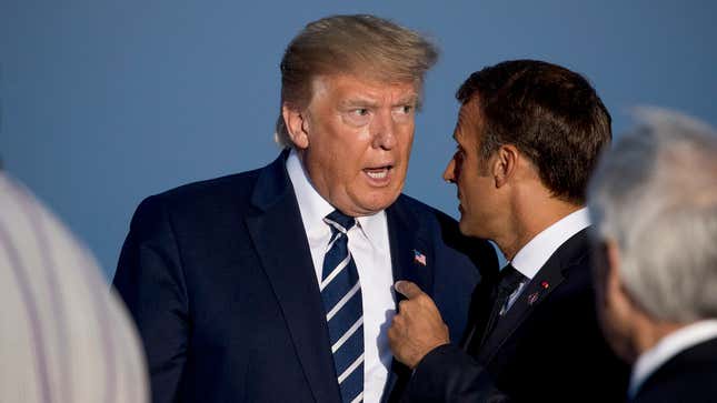 President Donald Trump, a confused and racist old man with a lukewarm dollop of moldy clam chowder where his brain should be, speaks with French President Emmanuel Macron at the G7 summit in France on August 25, 2019
