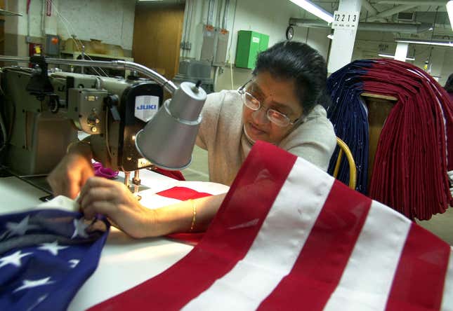 Sadgunaben Patel adjusts her sewing machine as she sews an American Flag at Annin Flags, April 7, 2003, in Oaks, Pennsylvania