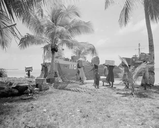 Residents of Bikini Atoll load their belongings onto an American LST for evacuation to Rongerik Atoll, 109 miles away.