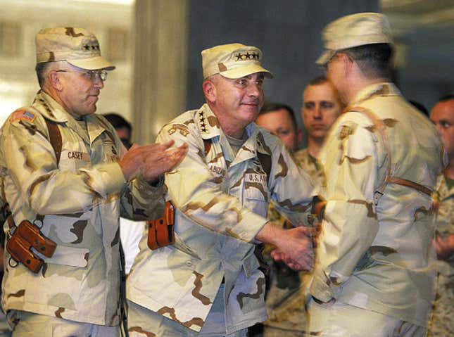 Casey (left) and Lt. Gen. John Abizaid shake hands with an enlisted soldier after the war.