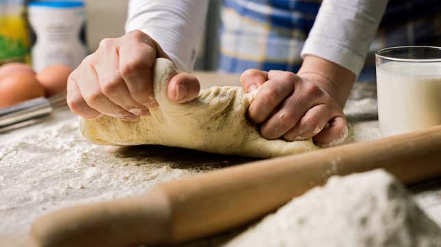 Hands kneading pizza dough